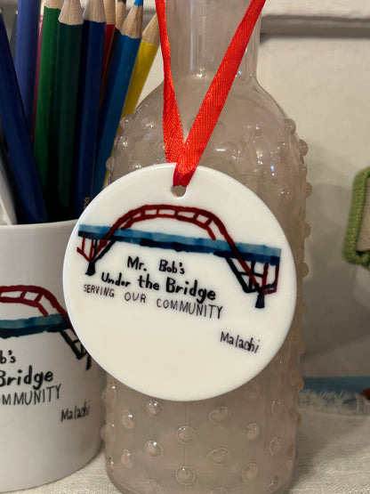 Products with Malachi’s Mr. Bob’s Under the Bridge Painting. Partial proceeds to be donated.