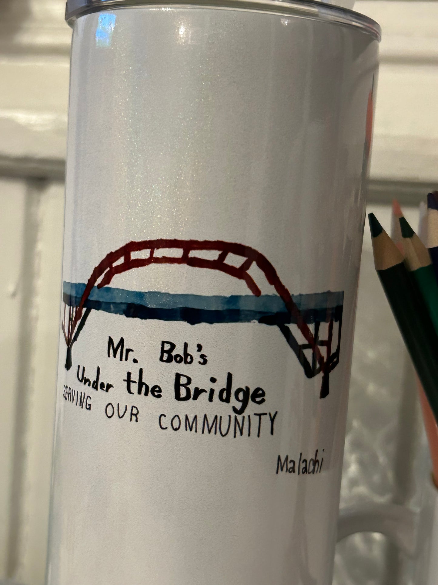 Products with Malachi’s Mr. Bob’s Under the Bridge Painting. Partial proceeds to be donated.